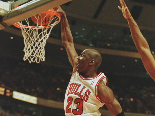 27 Feb 1996:  Shooting guard Michael Jordan of the Chicago Bulls focuses on the rim as he is caught in mid air attempting a slam dunk during the Bull's 120-99 victory over the Minnesota Timberwolves at the United Center in Chicago, Illinois.   Mandatory Credit: Brian Bahr/ALLSPORT