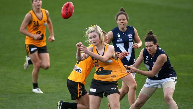 PERTH, AUSTRALIA - JUNE 05: Hayley Miller of Western Australia gets her handball away while being tackled by Elise O'Dea of Victoria during the AFL State Women's Game between Western Australia and Victoria at Domain Stadium on June 5, 2015 in Perth, Australia. (Photo by Paul Kane/Getty Images)