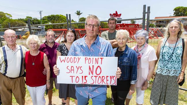 Derek Catterall poses for a photograph with neighbours of the development site bounded by Kate Street, Lilla Street, and Gayundah Esplanade in Woody Point. PHOTO: AAP /Richard Walker