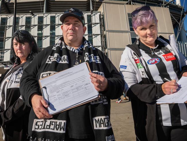 Pies fans are agitating to overthrow the board.Members signing petition floating Before the Magpies and Port Adelaide game at MCG Petition organiser David Hatley (40 year Collingwood member), with members Colleen Riding and Maxine Willis. Picture: Tony Gough