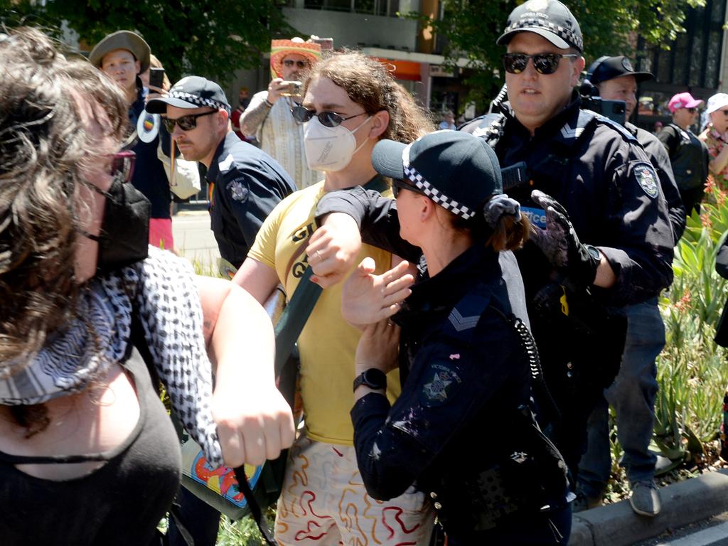 A small group of protesters clash with police who were taking part in the march along Fitzroy St. Picture: Andrew Henshaw