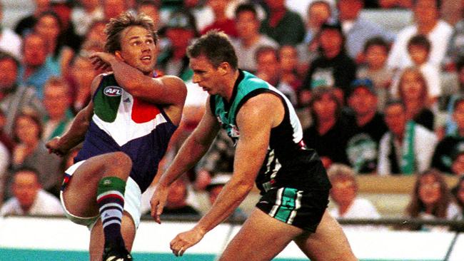 Footballer Tony Modra (l) kicking over Stephen Paxman (r).ALF Football - Port Adelaide Power vs Fremantle match at Football Park 18 Mar 2000.  a/ct/Football/AFL