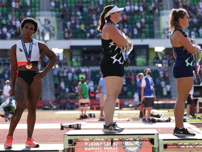 EUGENE, OREGON - JUNE 26: Gwendolyn Berry (L), third place, turns away from U.S. flag during the U.S. National Anthem as DeAnna Price (C), first place, and Brooke Andersen, second place, also stand on the podium after the Women's Hammer Throw final on day nine of the 2020 U.S. Olympic Track & Field Team Trials at Hayward Field on June 26, 2021 in Eugene, Oregon. In 2019, the USOPC reprimanded Berry after her demonstration on the podium at the Lima Pan-American Games. (Photo by Patrick Smith/Getty Images)