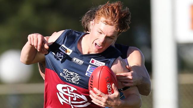 Sandhurst’s Noah Walsh is tackled by an Eaglehawk player. The team remains unbeaten in the Bendigo league. Picture Yuri Kouzmin