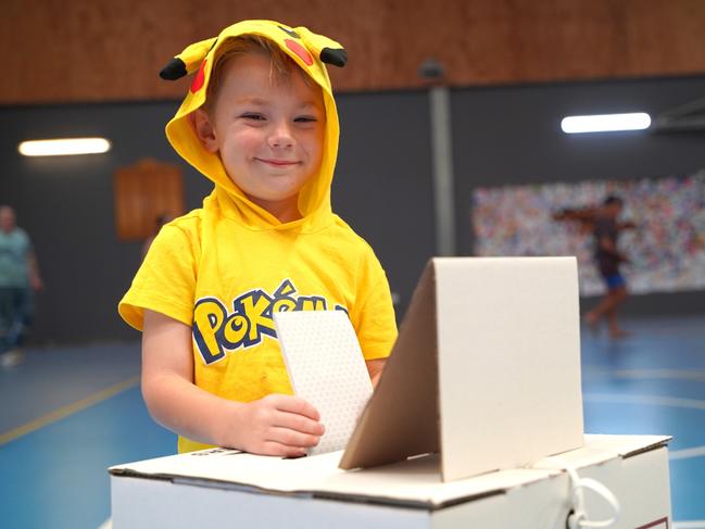 West Mackay resident Oliver Oxford, 5, helping his mum Taylor cast her vote at Victoria Park State School for the Mackay Regional Council elections on Saturday, March 16, 2024. Picture: Heidi Petith