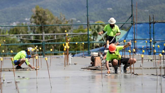 Tradesmen smoothing out the roof of the building during a concrete pour. Among the need to build more social housing. PICTURE: STEWART McLEAN