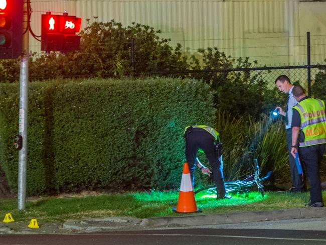 Police inspect the bike at the scene of the fatal crash. Picture by Gary Sissons