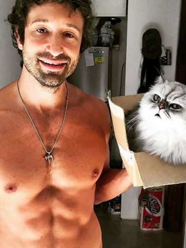 Cat in a box, and a hot man. What more could you want from a picture? Picture: instagram/hotdudeswithkittens.