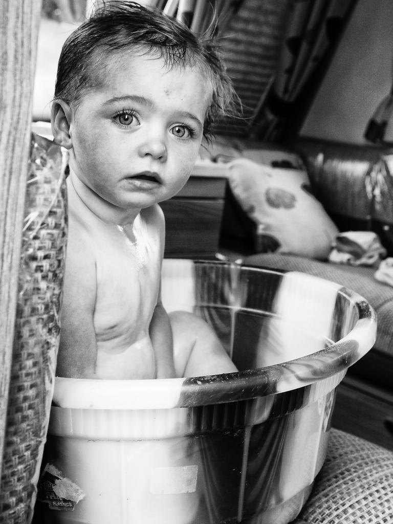 A young child sits in a tub. Picture: Jamie Johnson