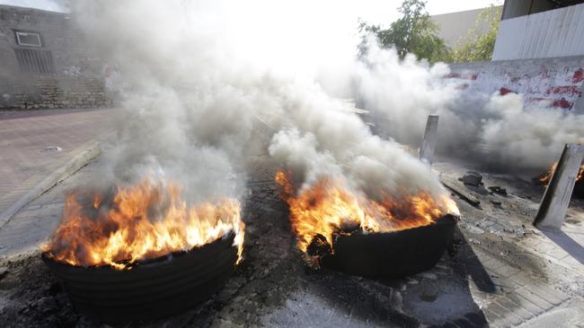 Tire fires burn in a third straight day of protests against Saudi Arabia's execution of Saudi Shiite cleric Sheikh Nimr al-Nimr in the western Shiite village of Karzakan, Bahrain, Monday, Jan. 4, 2016. Allies of Saudi Arabia, including neighboring Bahrain, followed the kingdom's lead on Monday and began scaling down their diplomatic ties to Iran in the wake of the ransacking of Saudi diplomatic missions in Iran after al-Nimr's execution. (AP Photo/Hasan Jamali)