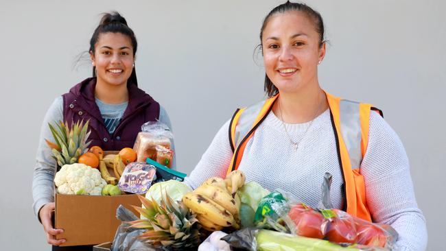 ReachOut volunteer Natalina Suaalii and Director Salina Chou with the hampers prepared by Reach Out. The organisation helps provide food to those struggling in the community. Picture: Angelo Velardo.