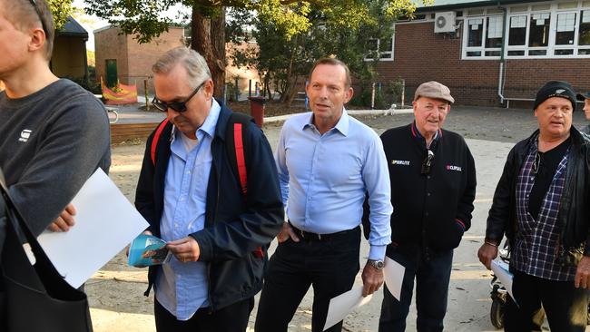 Mr Abbott takes his place in the queue as he waits to vote at Forestville Public School on Saturday.