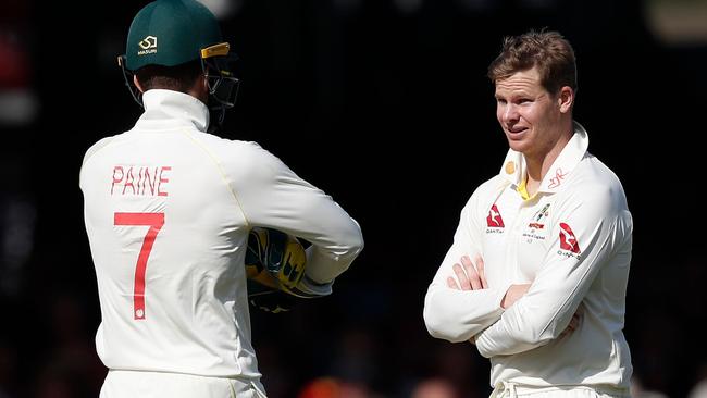 Tim Paine (left) and Steve Smith weigh up whether to review an unsuccessful LBW appeal. Picture: AFP.