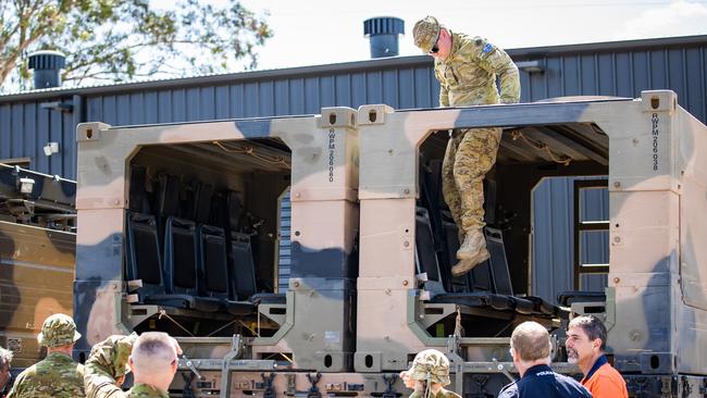 Emergency services and Australia Defence Force personnel with two of the high clearance vehicles deployed for the Murray River floods. Picture: Tom Huntley