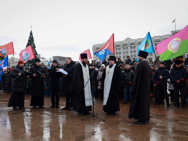 Mourners gather with priests to lay flowers in memory of more than 60 Russian soldiers that Russia says were killed in a Ukrainian strike on Russian-controlled territory, in Samara, on January 3, 2023. Picture: Arden Arkman / AFP.