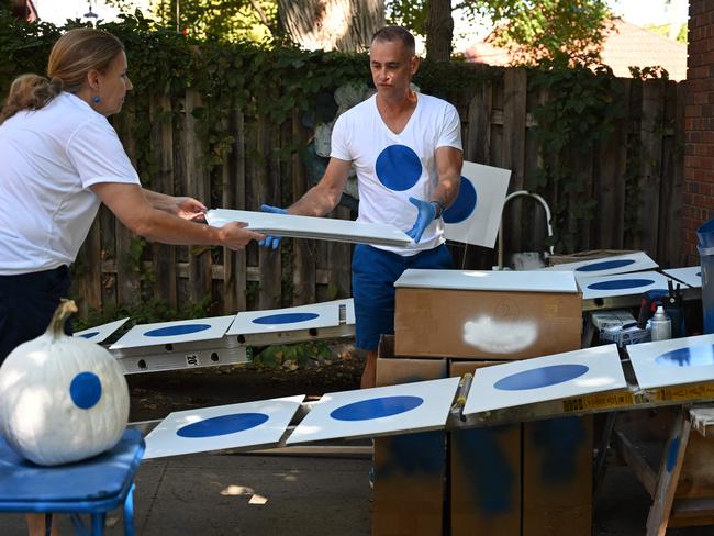 Jason Brown and his wife Ruth Brown handcraft political signs featuring a simple blue dot, at their home in Omaha, Nebraska, on September 30, 2024. Nestled deep in America's heartland, Nebraska is best known for corn, cattle and college football -- not usually for its elections. That could be about to dramatically change. A strange quirk of the devoutly Republican state's constitution essentially gives Omaha -- the largest city -- its own distinct and powerful vote for the next US president, in a race that remains too close to call just one month out. In the far-from-impossible scenario that Kamala Harris and Donald Trump are otherwise tied in the Electoral College that determines the White House's next occupant, this tiny Democratic-leaning "blue dot" of 650,000 people could have the final say. (Photo by Alex WROBLEWSKI / AFP)