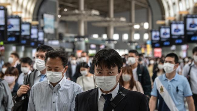 Tokyo commuters took to wearing masks in large numbers. Widespread use of masks appears to slow the spread of the coronavirus. Picture: Getty Images