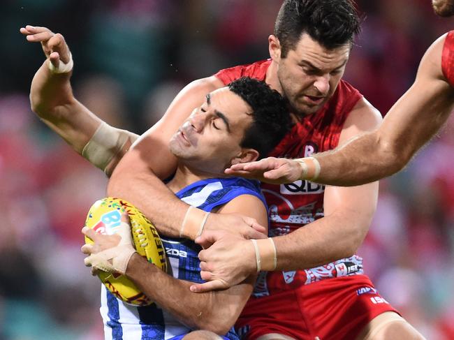 Heath Grundy of the Swans is penalised for this high tackle on Lindsay Thomas of the Kangaroos during the Round 10 AFL match between the Sydney Swans and the North Melbourne Kangaroos at the Sydney Cricket Ground in Sydney, Friday, May 27, 2016. (AAP Image/Dean Lewins) NO ARCHIVING, EDITORIAL USE ONLY