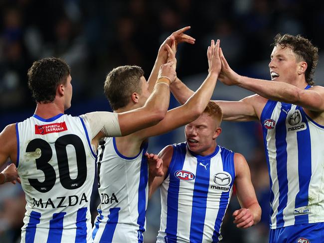 MELBOURNE, AUSTRALIA - APRIL 21: Nick Larkey of the Kangaroos is congratulated by team mates after kicking a goal during the round six AFL match between North Melbourne Kangaroos and Hawthorn Hawks at Marvel Stadium, on April 21, 2024, in Melbourne, Australia. (Photo by Quinn Rooney/Getty Images)