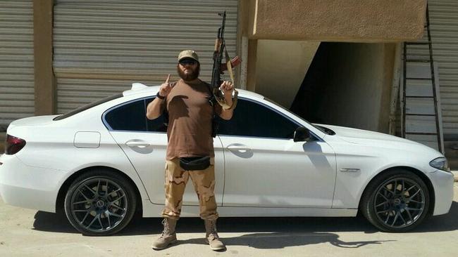 Khaled Sharrouf poses with an AK-47 in front of a sports car from an undisclosed location within Iraq. Picture: Twitter