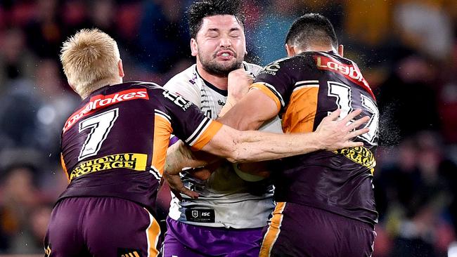 BRISBANE, AUSTRALIA - JULY 24: Brandon Smith of the Storm takes on the defence during the round 11 NRL match between the Brisbane Broncos and the Melbourne Storm at Suncorp Stadium on July 24, 2020 in Brisbane, Australia. (Photo by Bradley Kanaris/Getty Images)