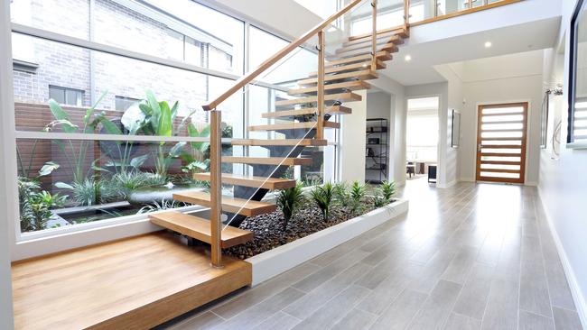 An indoor garden under a staircase is a clever use of space that extends the garden from outside to indoors. Picture: Designer Staircases