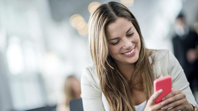 Happy woman texting on her smartphone. Picture: iStock.