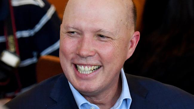 Australia's Minister for Home Affairs, Peter Dutton (centre) is seen with diners at the Golden Lane Chinese Restaurant in Brisbane, Friday, February 28, 2020. Minister Dutton is encouraging Australians to keep eating out at Chinese restaurants as they have seen a drop in customers since the outbreak of the COVID-19 coronavirus. (AAP Image/Darren England) NO ARCHIVING