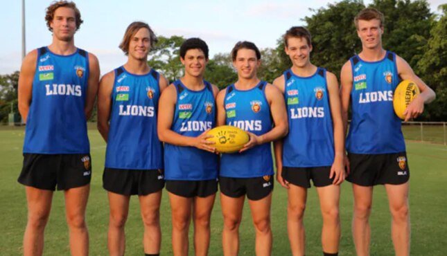 Chris Johnson’s son Lachlan (third from left) will have to decide between Brisbane or Essendon. 