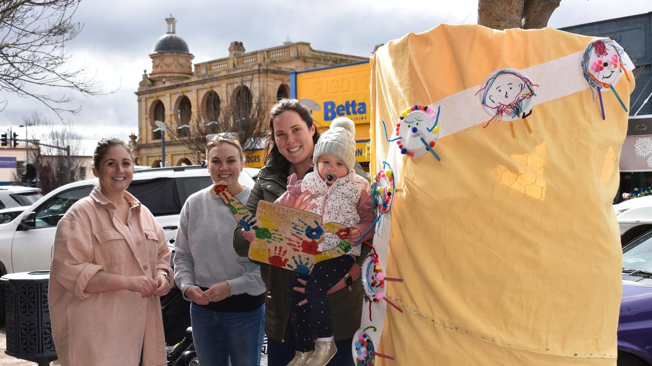 Emily Cross, Lisa Willi, and Melissa and Matilda Thompson setting up the tree jumper created by St Mary's Kindergarten pupils for this year's Jumpers and Jazz in July festival. Photo Jessica Paul / Warwick Daily News