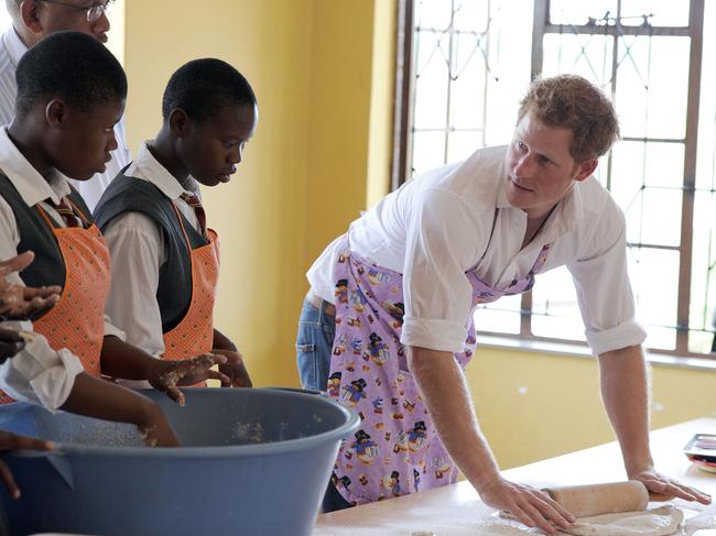 Prince Harry bakes at the Kananelo Centre in Maseru for the Deaf that works with Sentebale, an organisation he created with Prince Seeiso of Lesotho in 2006, during a visit in 2013. Prince Harry has quit as patron of the charity. Picture: Stephane de Sakutin/AFP