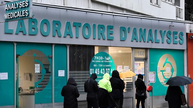 Patients wait to be tested for Covid-19 outside a laboratory in Paris. Picture: AFP