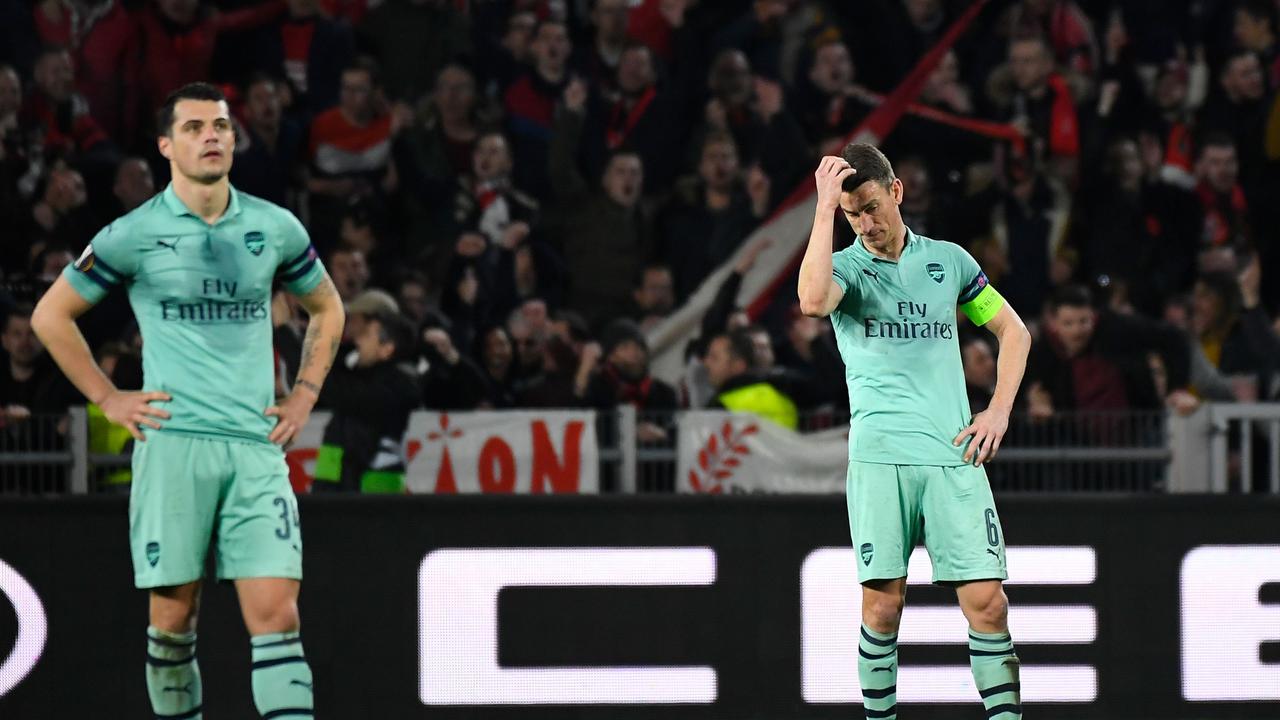 The Arsenal players react after being humbled by Rennes.