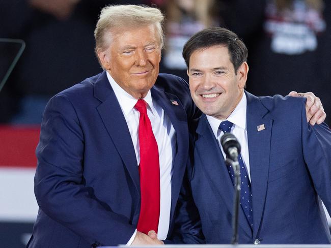 (FILES) Former US President and Republican presidential candidate Donald Trump greets Senator Marco Rubio, Republican of Florida, during a campaign rally at the J.S. Dorton Arena in Raleigh, North Carolina, on November 4, 2024. President-elect Trump is expected to name Rubio as secretary of state, The New York Times reported late on November 11, 2024. It quoted three people as saying that the decision is not final, but that Trump appears to have settled on Rubio, a loyalist whom Trump passed over as his vice presidential running mate. (Photo by Ryan M. Kelly / AFP)