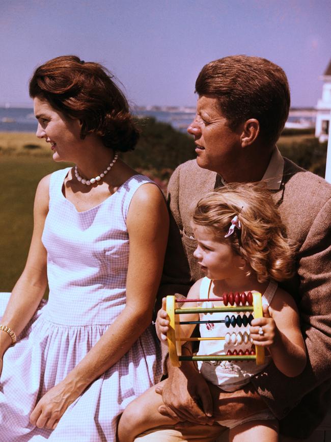 Senator John F. Kennedy relaxes with his wife Jacqueline and daughter Caroline.