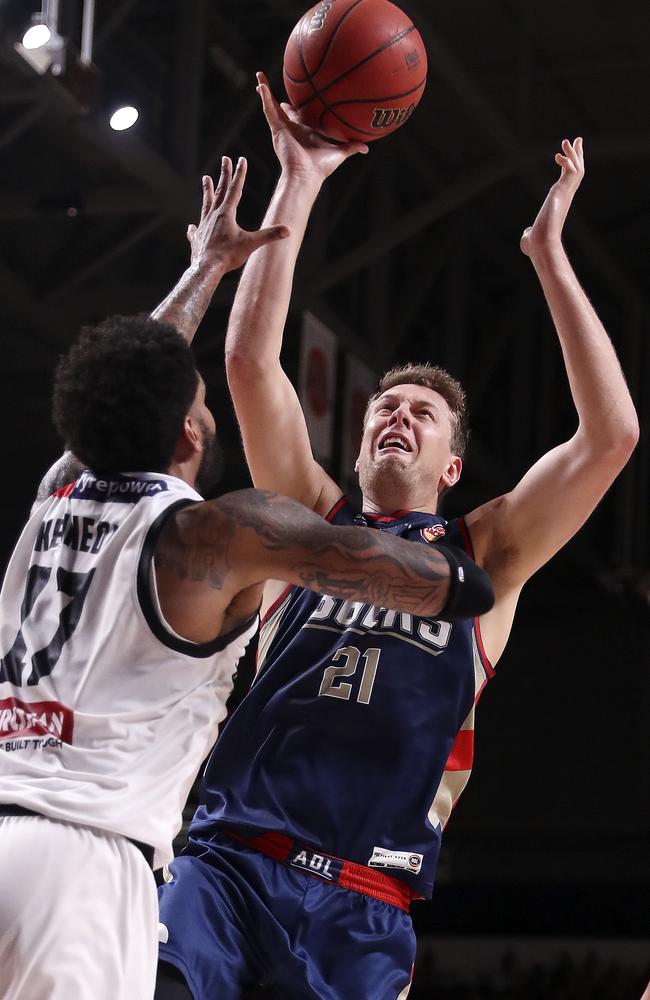 Adelaide 36ers’ Daniel Johnson shoots over DJ Kennedy. Picture: SARAH REED