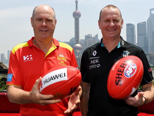 Gold Coast Sun's Rodney Eade (left) and Port Adelaide Power coach Ken Hinkley pose for photographs at a press conference at Bar Rouge in Shanghai, Thursday, May 11, 2017. (AAP Image/Tracey Nearmy) NO ARCHIVING