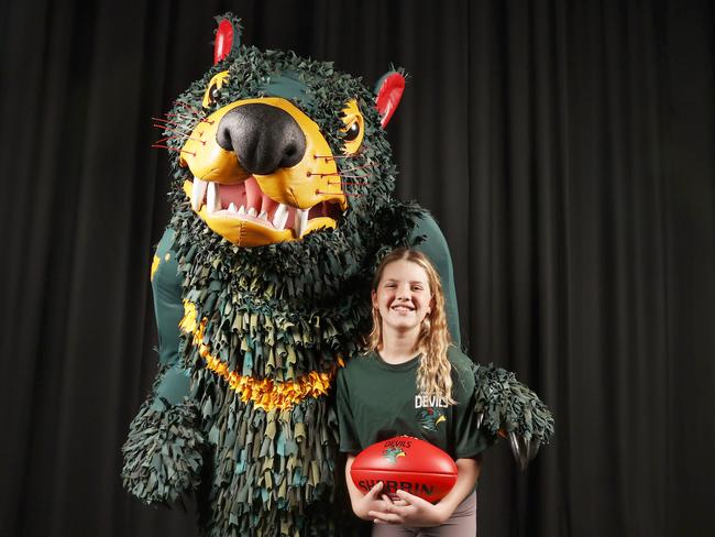 Tasmania Football Club mascot Rum'un with North Hobart junior player Katie Foale 11. Picture: Nikki Davis-Jones