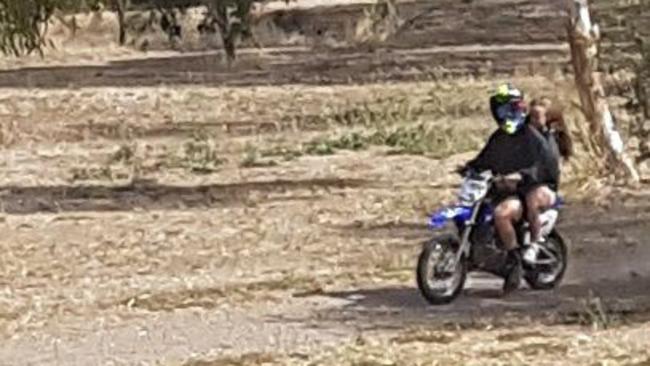 A motorbike rider with a passenger, caught on camera riding through Wilfred Taylor Reserve, Morphett Vale.