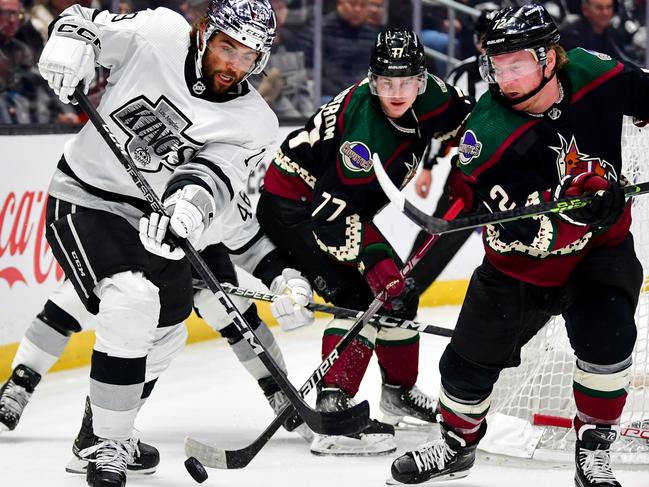 LOS ANGELES, CA - FEBRUARY 18: Alex Iafallo #19 of the Los Angeles Kings and Nick Ritchie #12 of the Arizona Coyotes battle for position during the third period at Crypto.com Arena on February 18, 2023 in Los Angeles, California. (Photo by Gary A. Vasquez/NHLI via Getty Images)