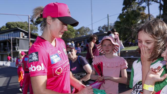 Ellyse Perry of the Sydney Sixers signs autographs during a Women’s Big Bash League at Hurstville Oval. Picture: Getty Images