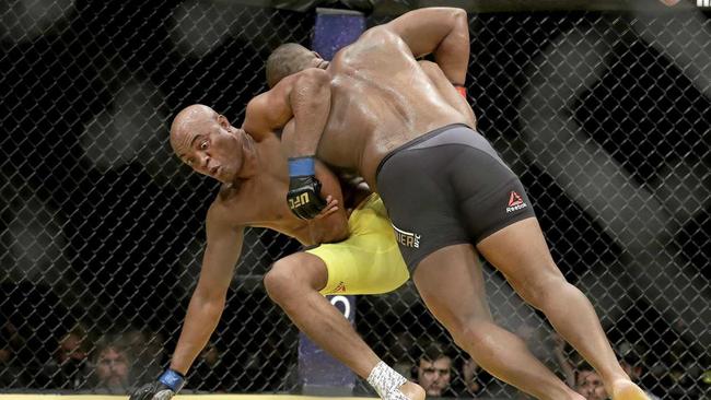 BATTLE: Daniel Cormier (right) takes down Anderson Silva during their light heavyweight mixed martial arts bout at UFC 200. Picture: John Locher-AAP