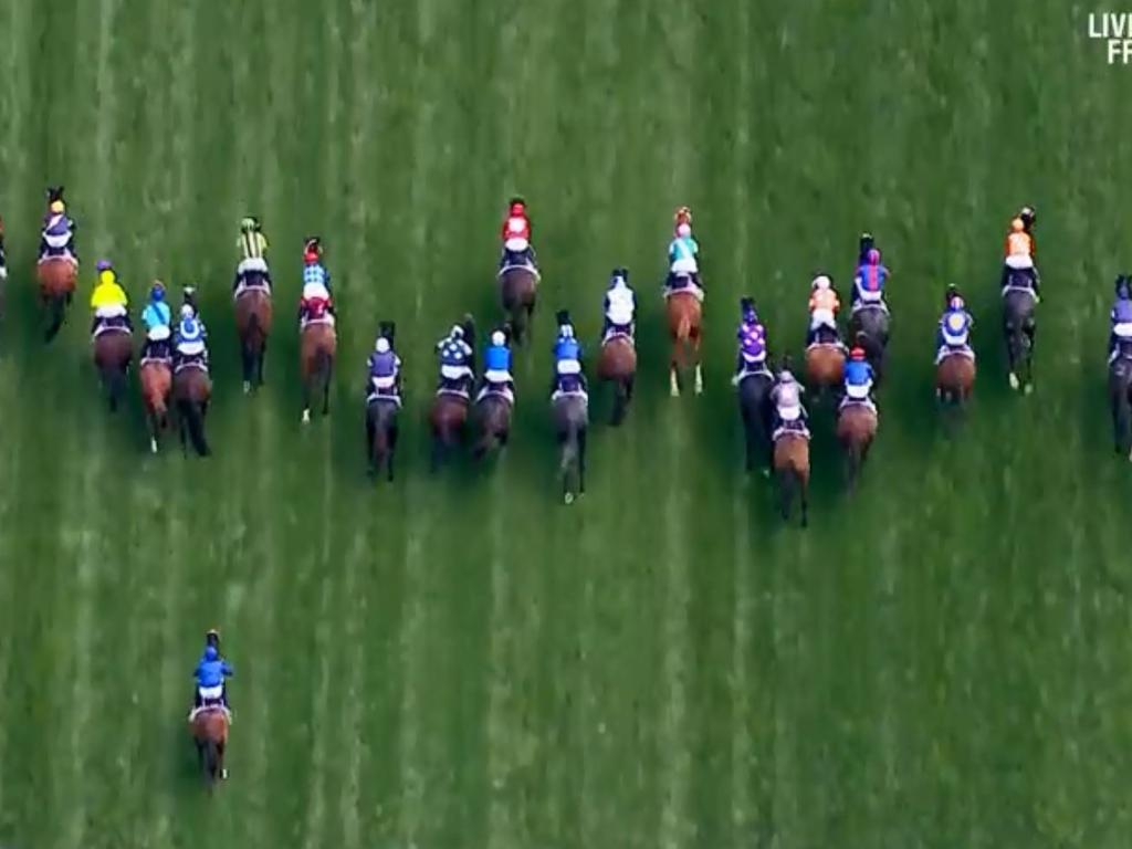 The horses after jumping out of the gates, Cross Counter fifth from the right in the red cap.