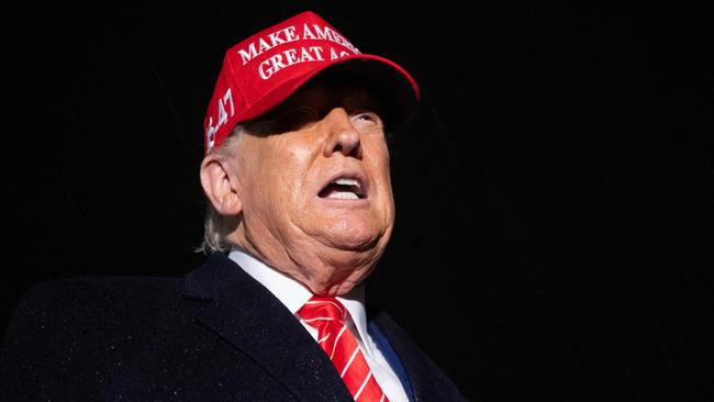 US President Donald Trump speaks to the press in the rain after landing on Air Force One at Joint Base Andrews in Maryland, May 30, 2025, after traveling to Pennsylvania to visit a US Steel plant. (Photo by SAUL LOEB / AFP)