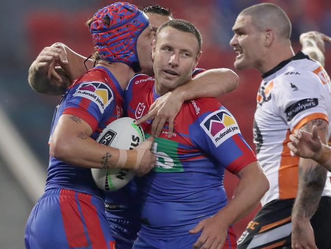 NEWCASTLE, AUSTRALIA - AUGUST 08: Kalyn Ponga of the Newcastle Knights celebrates a try with team mate Blake Green during the round 13 NRL match between the Newcastle Knights and the Wests Tigers at McDonald Jones Stadium on August 08, 2020 in Newcastle, Australia. (Photo by Ashley Feder/Getty Images)