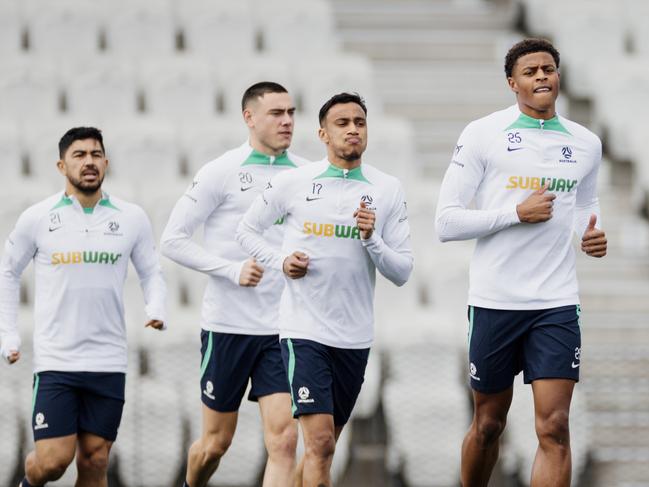 Socceroos players led by uncapped forward Kusini Yengi (centre) do run-throughs at Lakeside Stadium on Tuesday. Picture: Socceroos