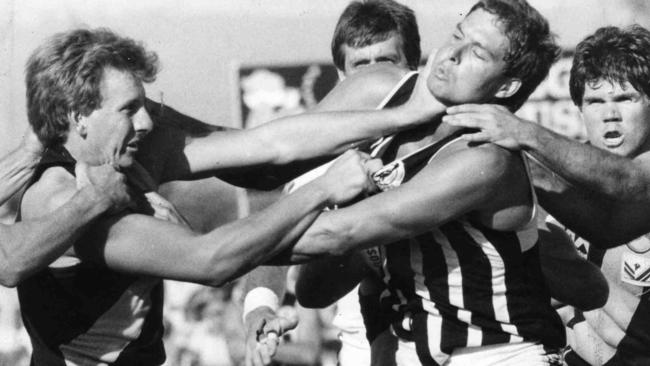 GETTING PHYSICAL: Alan Stringer comes to grips with Port Adelaide’s Martin Leslie during a match at the Bay in 1986. 