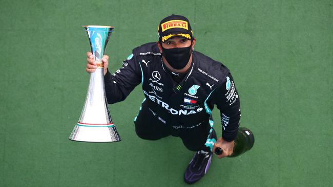 Hamilton celebrates with the trophy after winning the Hungarian GP. Picture: AFP