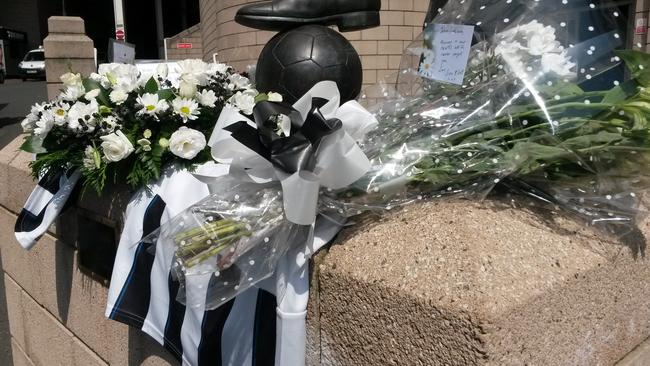 Flowers and football shirts are laid around the Sir Bobby Robson statue outside St. James Park.