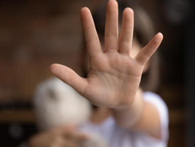 Crop close up of little girl child stretch hand show no gesture protest against domestic violence. Small teen child stand against discrimination or school abuse. Childhood problem, voice concept.